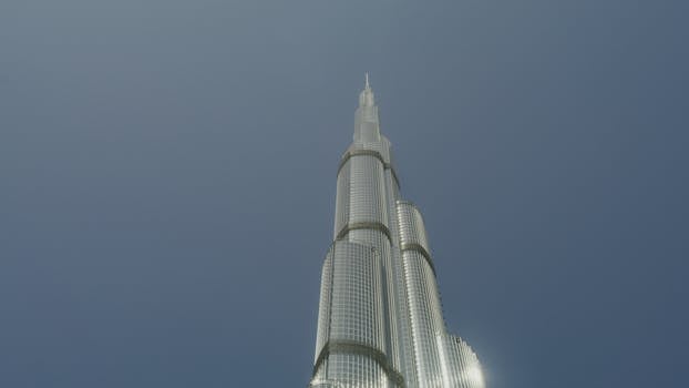 Iconic Burj Khalifa towering in Dubai against a vivid blue sky,